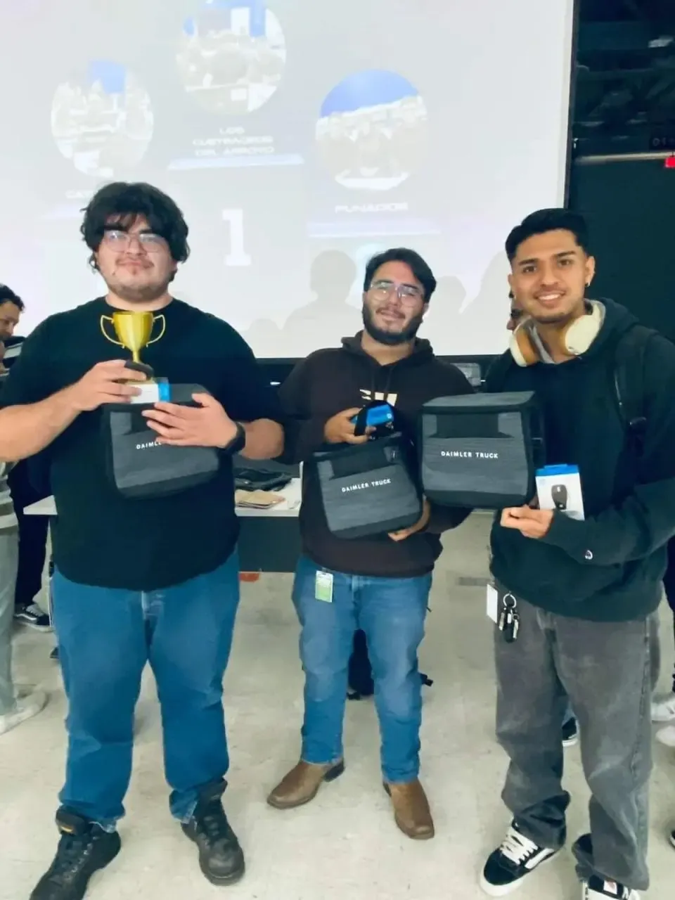 The team holding the Daimler Truck Hackathon trophy